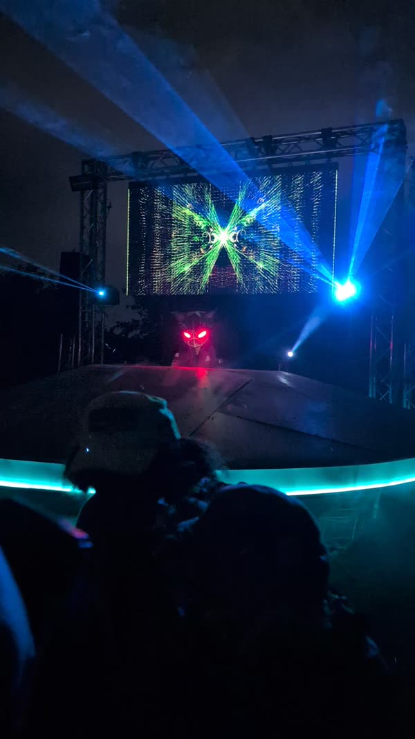 Round festival stage with LED edge lighting and blue beams
